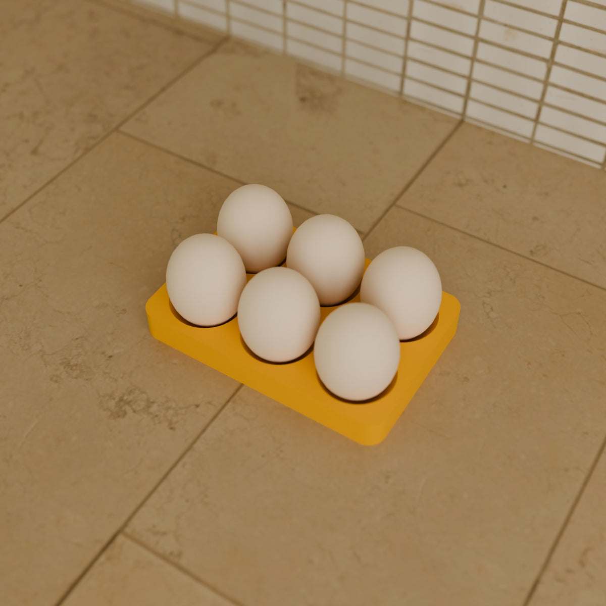 6-Egg Fridge Tray in Matte Yellow PLA, holding six eggs on a kitchen counter