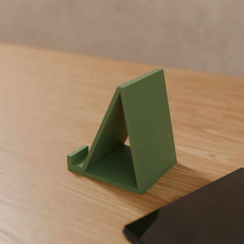 Angled Phone Stand in Matte Sage Green PLA, on a wooden desk