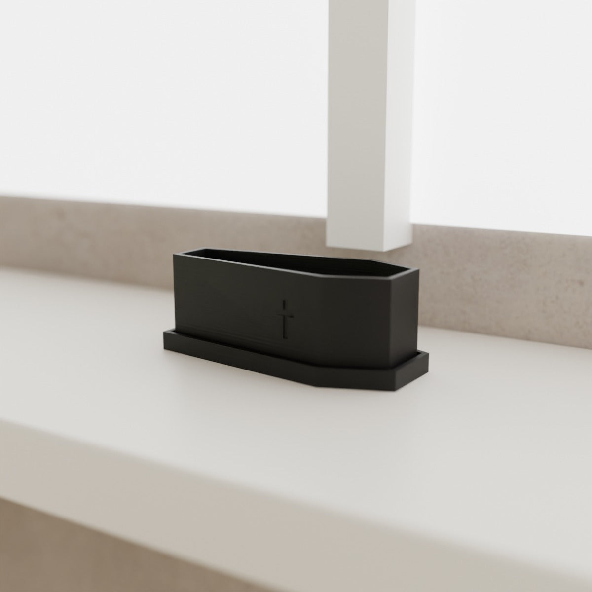 Coffin Planter with Saucer (Small 105 mm) in Matte Black PLA, on a white windowsill