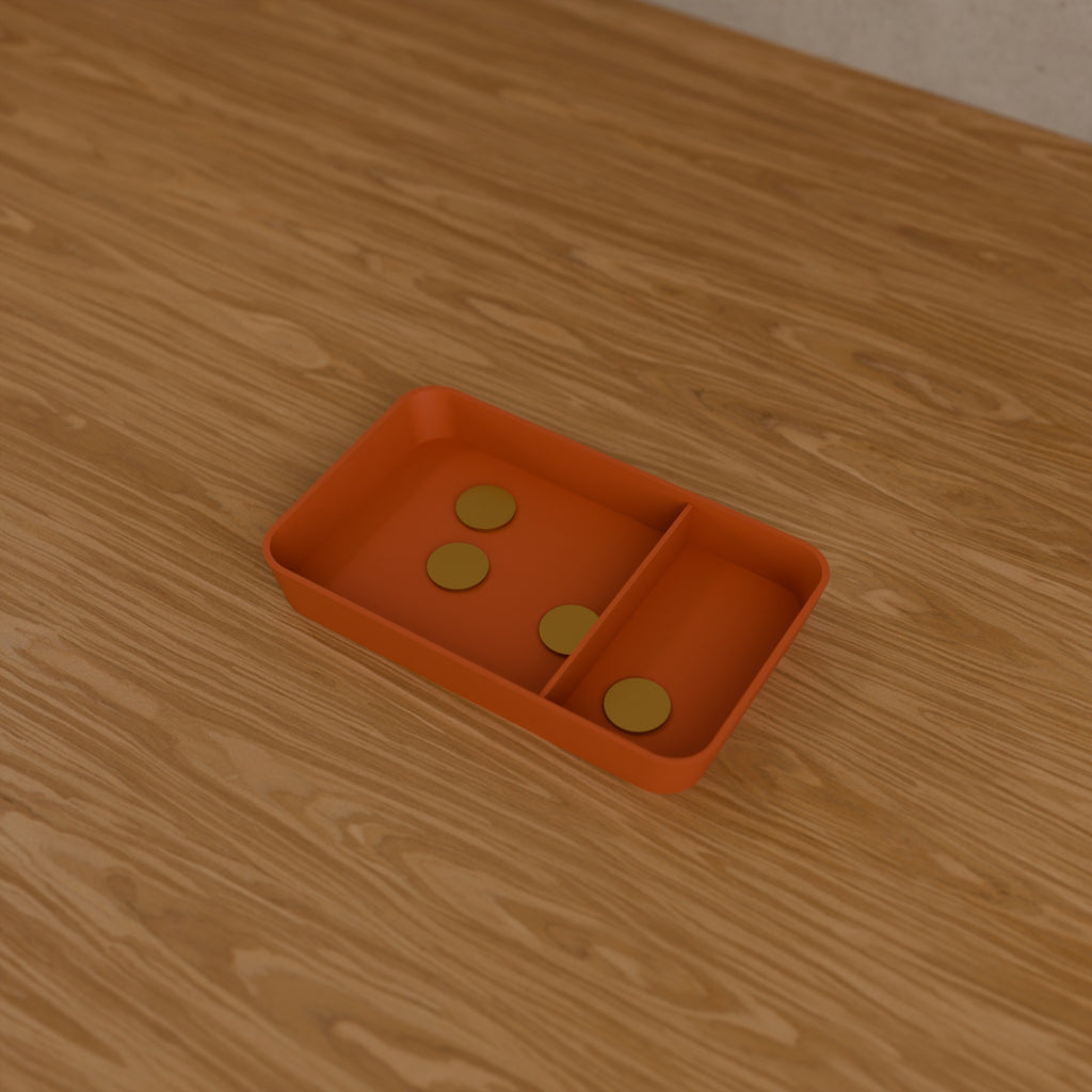 Desk Catch-All Tray in Matte Terracotta PLA, holding coins on a wooden desk