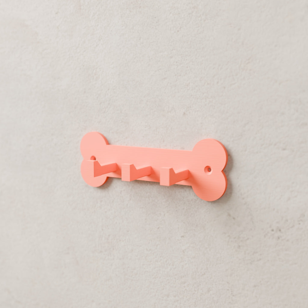 Dog Leash & Collar Rack in Matte Coral PLA, mounted on a wall