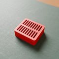 Handheld Game Card Holder in Bright Red PLA, on a game mat
