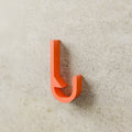 Heavy-Duty Utility Hook in Bright Orange PETG, mounted on a wall