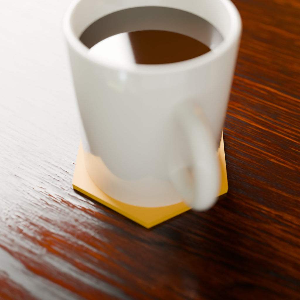Honeycomb Hex Coaster in Matte Yellow PLA, under a coffee mug on a wooden table