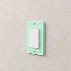 Light Switch Cover Plate (Decora / rocker) in Matte Mint PLA, on a wall around a rocker switch