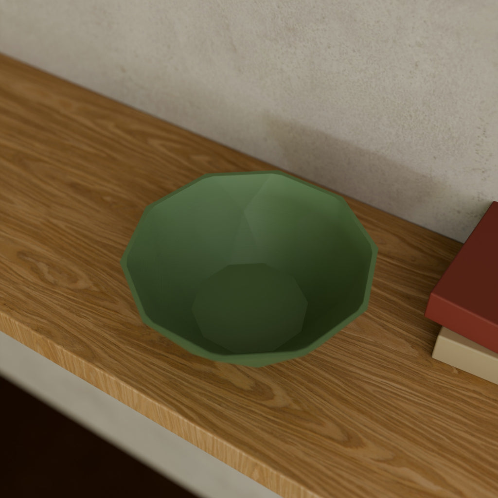 Low-Poly Geometric Bowl in Matte Sage Green PLA, on a wooden shelf
