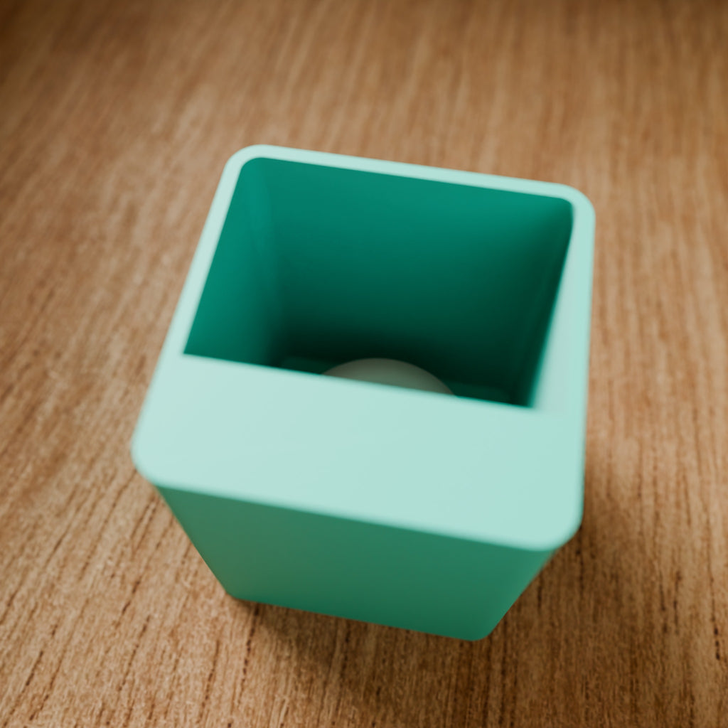 Modular Storage Bin (1x1) in Matte Teal PLA, on a wooden surface
