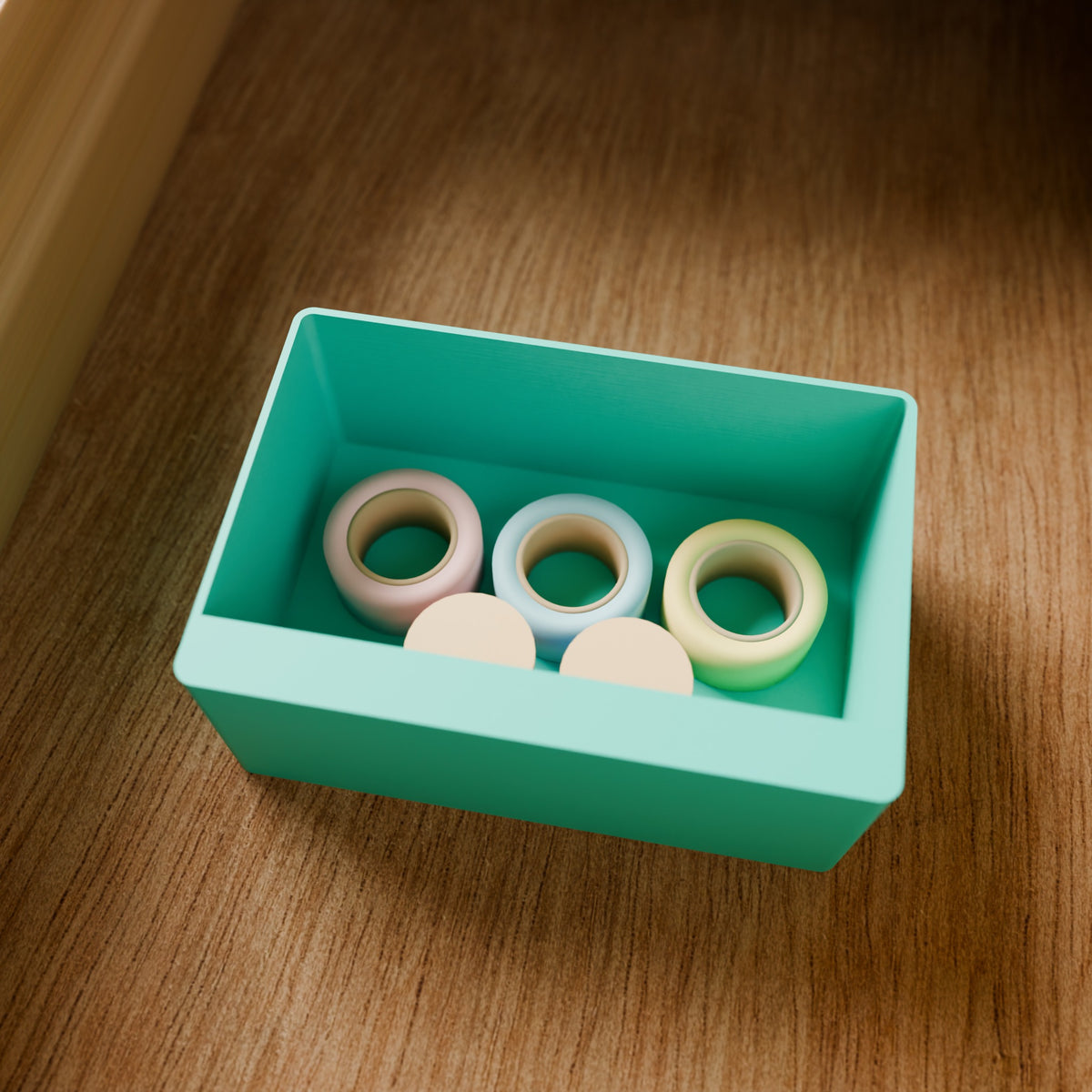 Modular Storage Bin (2x3) in Matte Teal PLA, holding tape rolls on a wooden surface