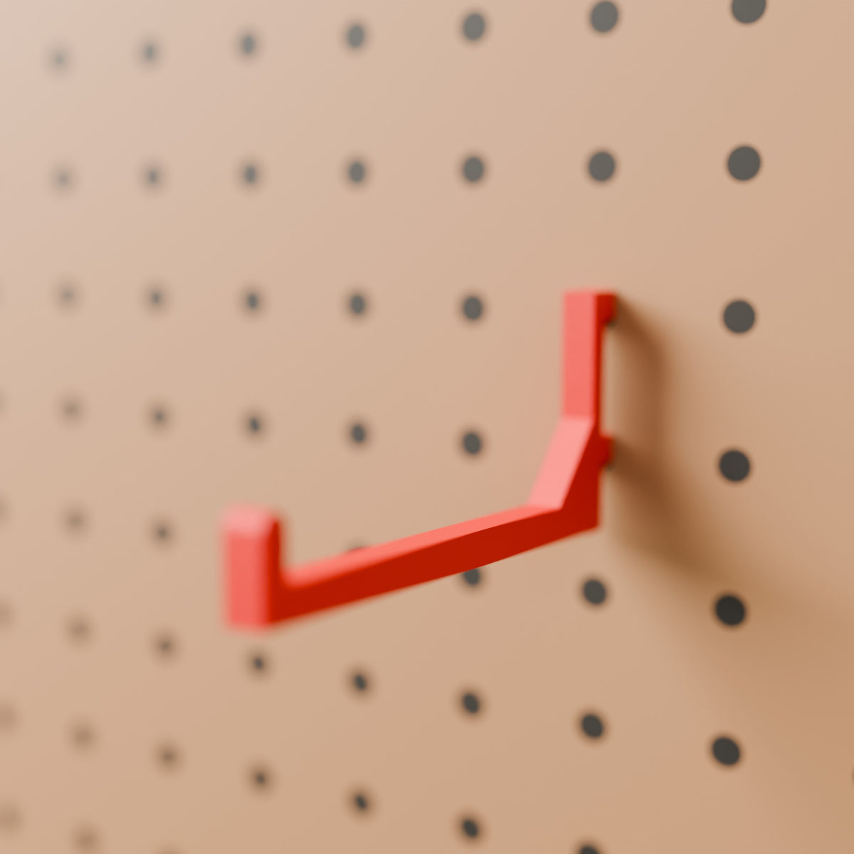 Pegboard Hook (100 mm reach) in Bright Red PLA, on a pegboard