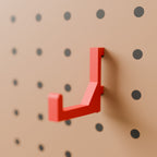 Pegboard Hook (50 mm reach) in Bright Red PLA, on a pegboard