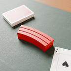 Playing Card Hand Holder in Bright Red PLA, with playing cards on a game mat