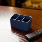 Remote Control Caddy in Matte Navy PLA, with a TV remote on a wooden table