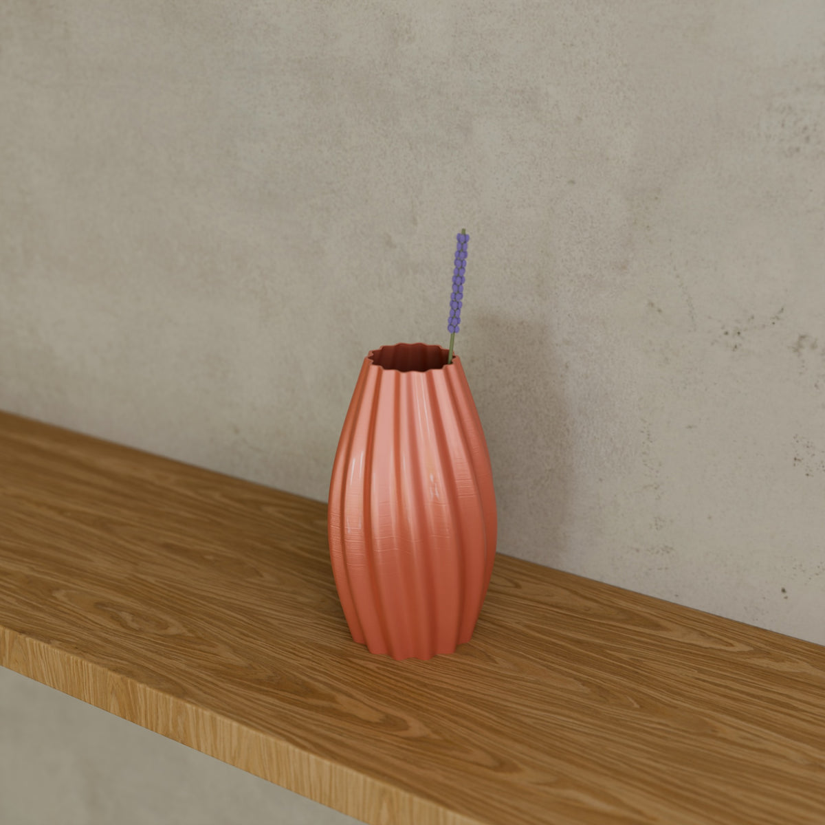 Ripple Bud Vase in Silk Rose Gold PETG, with a dried stem on a wooden shelf