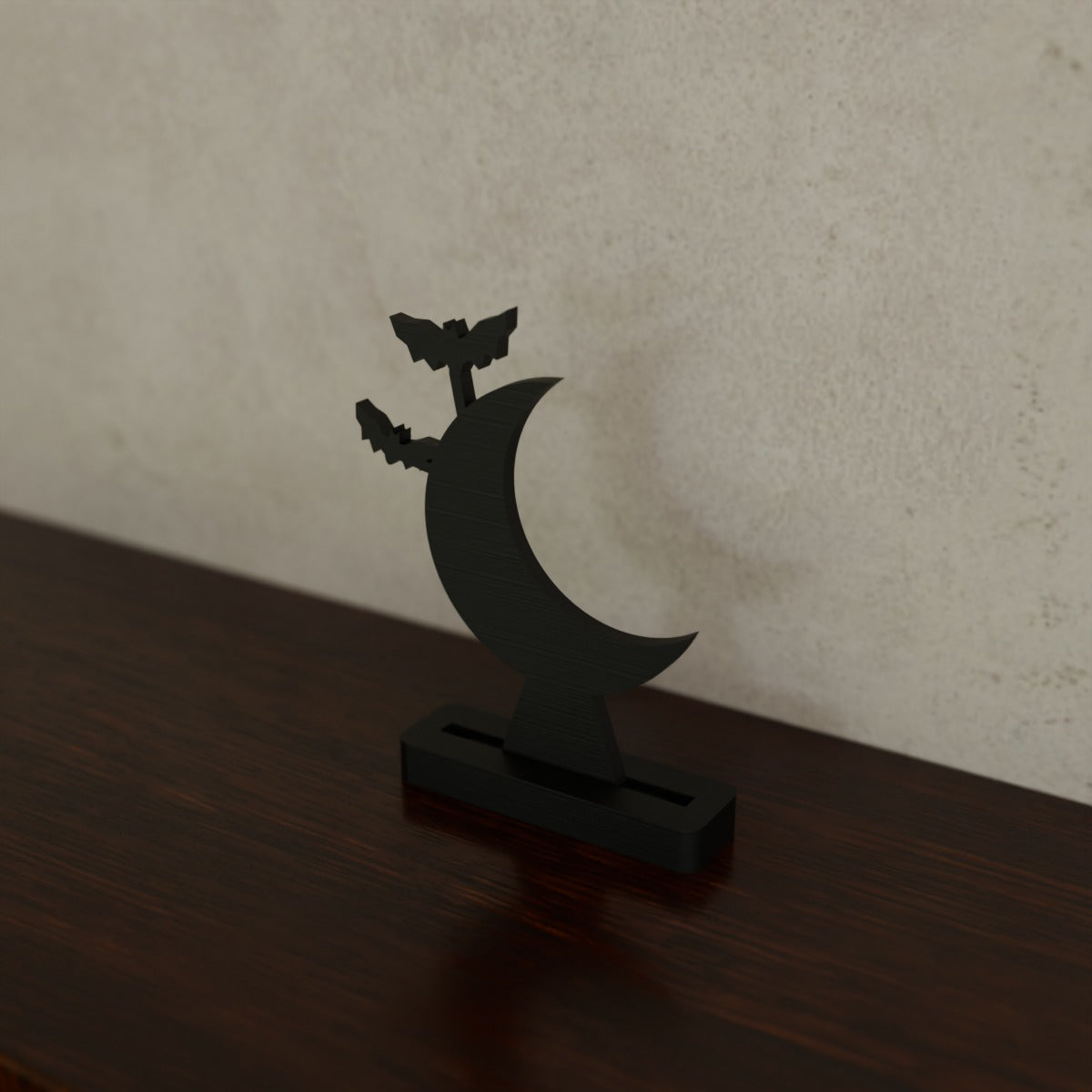 Spooky Silhouette Shelf Sitter (Bat moon) in Matte Black PLA, on a dark wooden shelf
