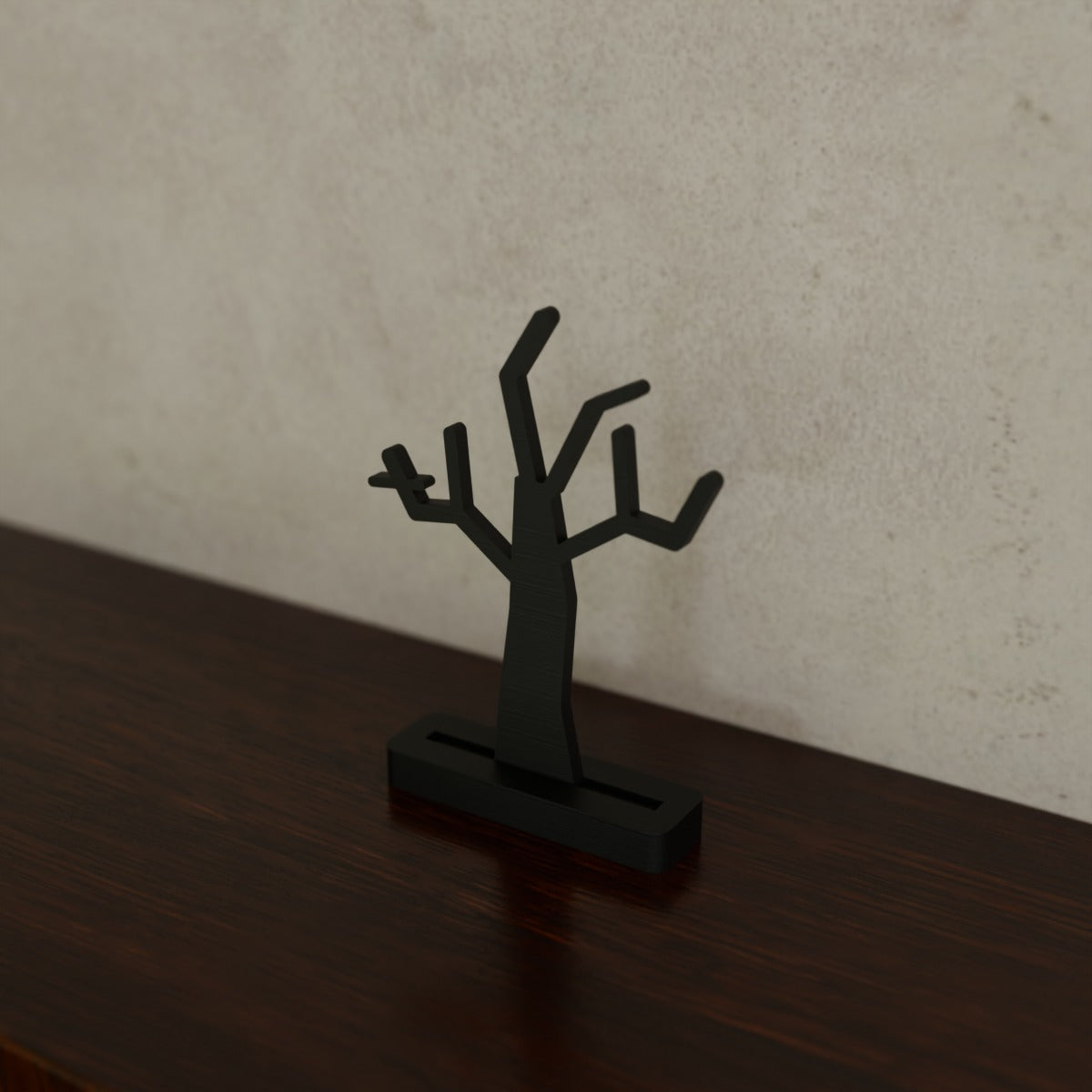 Spooky Silhouette Shelf Sitter (Crooked tree) in Matte Black PLA, on a dark wooden shelf