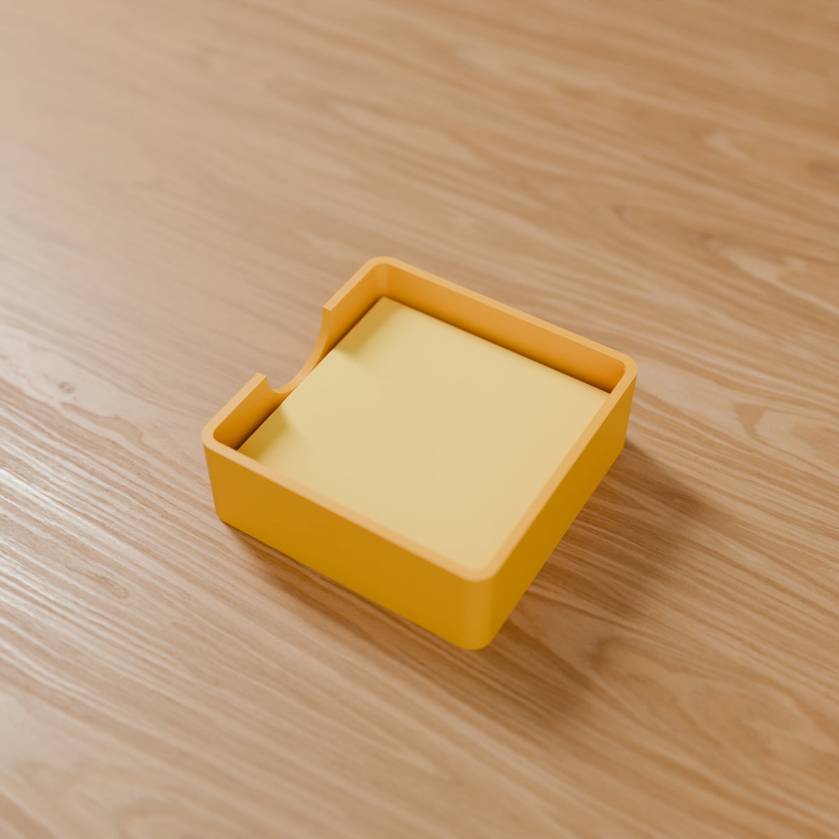 Sticky Note Holder in Matte Yellow PLA, holding a sticky-note pad on a wooden desk