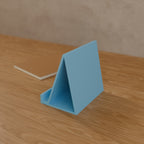 Tablet Stand in Matte Sky Blue PLA, on a wooden desk