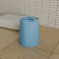 Toothbrush & Paste Holder in Matte Sky Blue PETG, on a bathroom counter