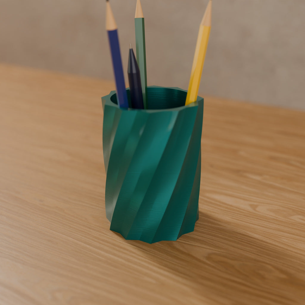 Twisted Star Pen Cup in Silk Teal PLA, holding pencils on a wooden desk
