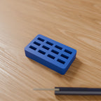 USB Flash Drive Holder in Matte Blue PLA, on a wooden desk