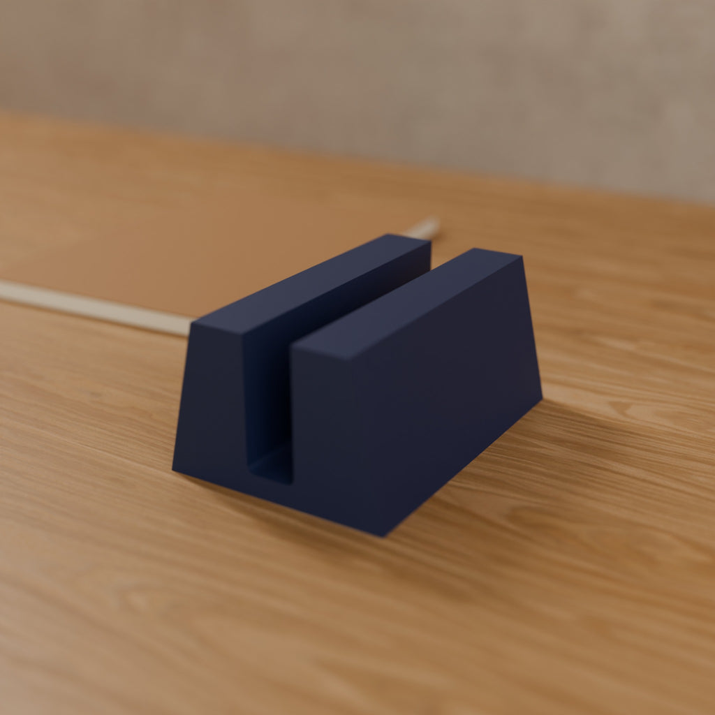 Vertical Laptop Stand (Slot 18 mm, thin ultrabooks) in Matte Navy PLA, on a wooden desk