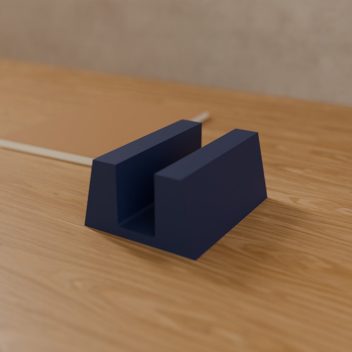 Vertical Laptop Stand (Slot 32 mm, gaming laptops) in Matte Navy PLA, on a wooden desk